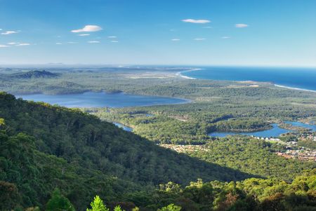 aerial viewpoint looking to the coast over a forested landscapeの写真素材