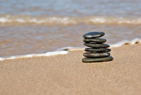 small pile of stones in tower on the beach