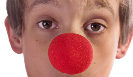 close up of a boys face with red noseの写真素材