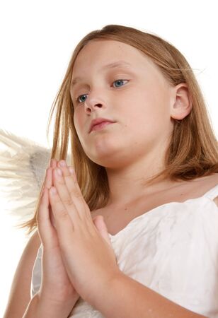 pure and innocent little angel fairy girl prayingの写真素材