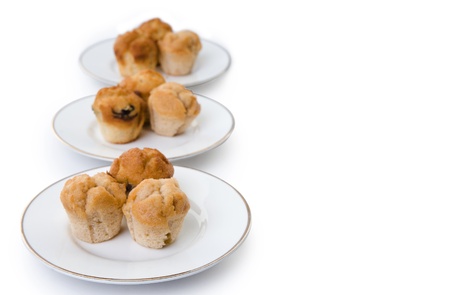 three plates of muffins in a row on whiteの写真素材