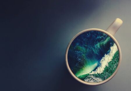 White cup with water. Sea Ocean Sea waves. Creative postcard.の写真素材