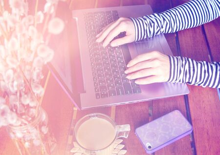 Workspace with coffee, purple laptop and a fresh bouquet of willow. Work in the office or at home...