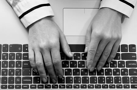 Laptop keyboard Female hands are typing on an English keyboard.