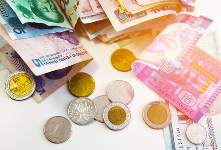 Money from around the world after traveling. Banknotes and metal coins of different denominations.