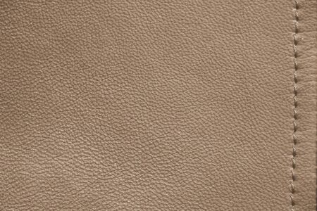 The texture of genuine leather. Brown background.