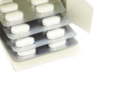 White pills. Blister with pills on a white background.の写真素材