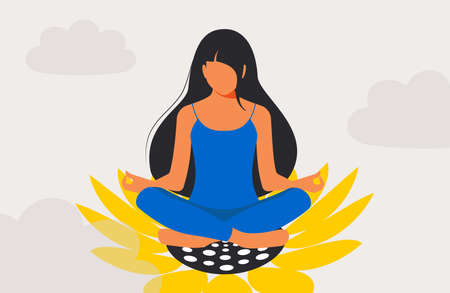 A beautiful woman with long black hair sits in a lotus position, meditates in a sunflower flower and feels great, radiating positive feminine energy. Be calm and take care of yourself.の写真素材