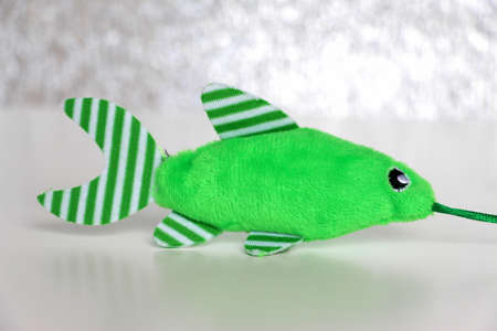 Green cute plush fish. Toy for cats. cat fishing.の写真素材