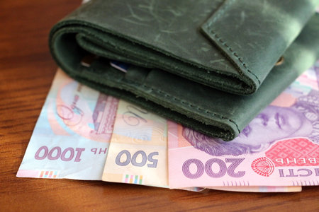 Ukrainian paper money in two hundred, five hundred and one thousand hryvnia bills. green wallet.