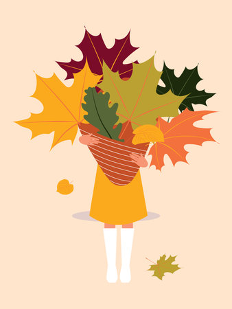 A girl in a yellow dress and white boots holds a huge bouquet of autumn leaves.の写真素材