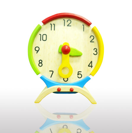 Colorful wooden clock isolated on a white background                               