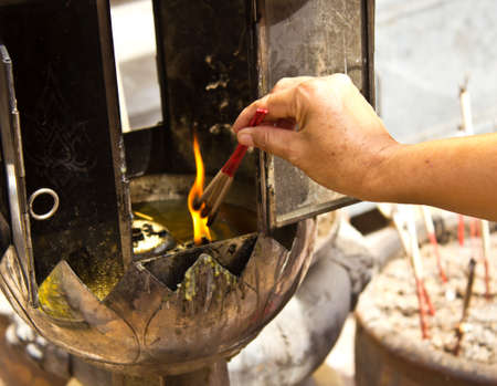 Burning incense stick, traditional buddhism ceremony in Thailandの写真素材