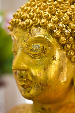 Close-up to golden Buddha faceの写真素材
