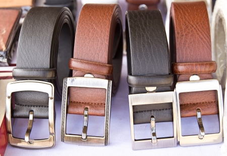 Closeup four leather belts on the tableの写真素材
