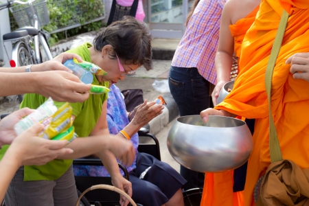 Phrae,Thailand - October 31,2012 : Unidentified Buddhist monks is given food offering from people at the morning on End of Buddhist Lent Day. on october 31, 2011 in Muang, Phrae, Thailand.のeditorial素材