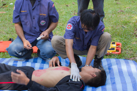 PHRAE,THAILAND - DECEMBER 20 : Unidentified  men are first aid training from staff  the hospital on  December 20, 2012 at local parks, Muang, Phrae, Thailand.のeditorial素材