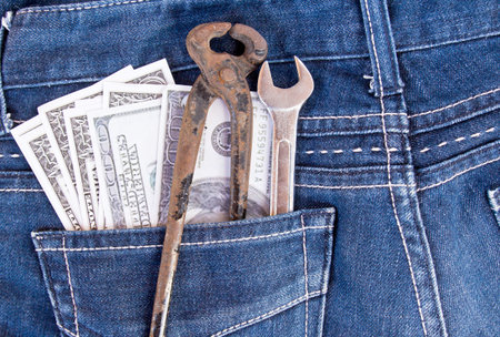 American dollar bills and tools in jeans pocket backgroundの写真素材