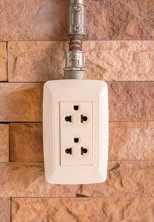 an image of plug on brick wall background