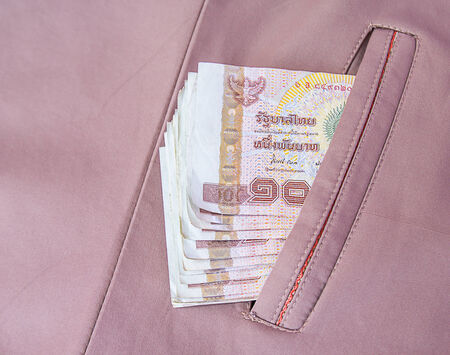 Money thai banknote in the brown coats pocketの写真素材
