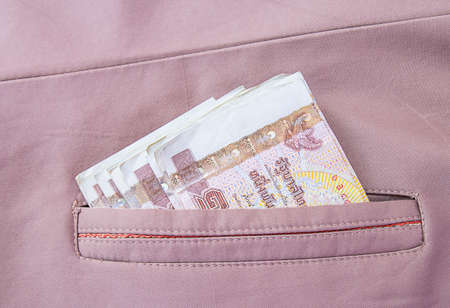 Money thai banknote in the brown coats pocketの写真素材