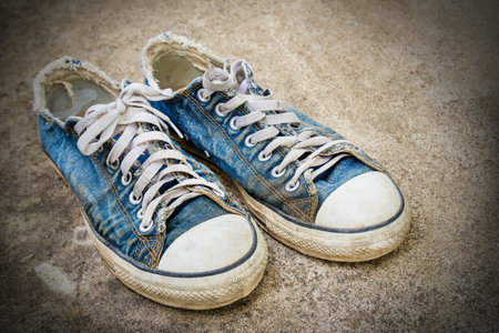 Dirty old shoes on the floorの写真素材