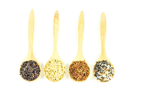 rice in wooden spoon isolated on white backgroundの写真素材