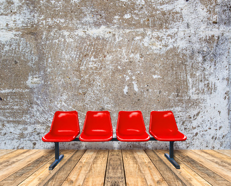 Red chair on wooden floor and grunge texture backgroundの写真素材