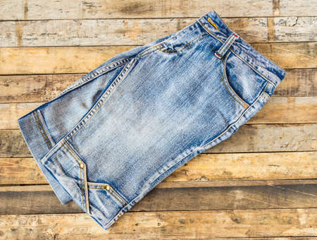 Blue jeans on old wooden surface backgroundの写真素材