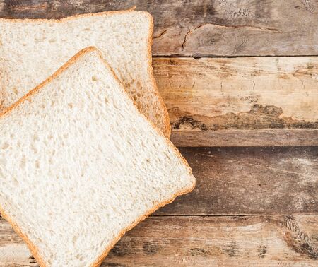 Close up slice bread on a wooden backgroundの写真素材