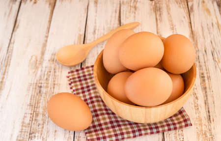 Close up chicken brown eggs on wooden backgroundの写真素材