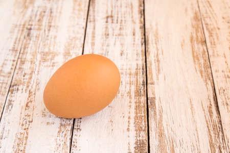Close up chicken brown eggs on wooden backgroundの写真素材