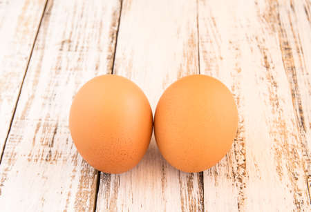 Close up chicken brown eggs on wooden backgroundの写真素材