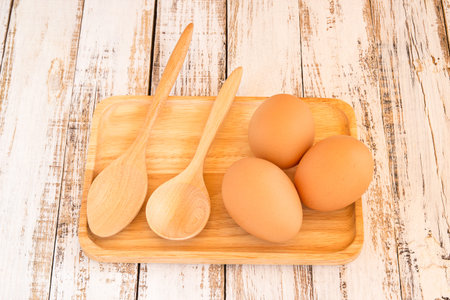 Close up chicken brown eggs on wooden backgroundの写真素材