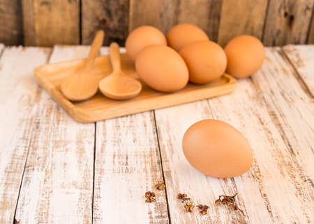 Close up chicken brown eggs on wooden backgroundの写真素材