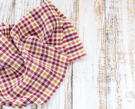 Top view of checkered napkin on white wooden tableの写真素材