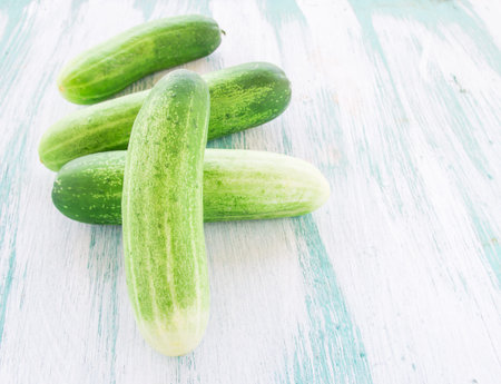 Fresh cucumbers on the wooden backgroundの写真素材