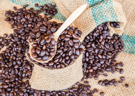 Coffee beans in coffee bag on sack surface backgroundの写真素材
