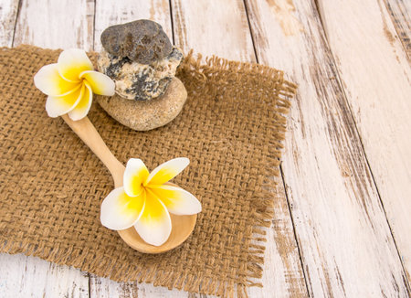 Fresh Tropical Plumeria in wooden spoon on burlap sack backgroundの写真素材