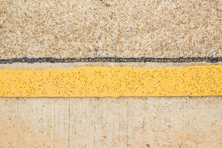 Close up yellow line on the road textureの写真素材