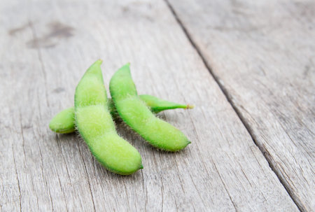 Fresh green soybeans on a wooden background.の写真素材