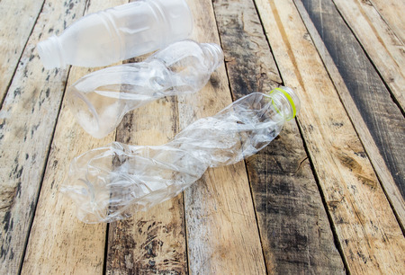 Plastic water bottles for recycle on the wooden table backgroundの写真素材