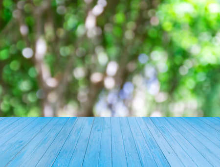 Blue wooden table with blurred background for any designの写真素材