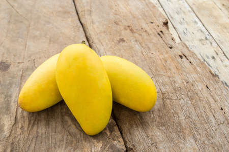 Close up ripe mango on a wooden floorの写真素材