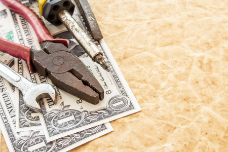 The dollar banknotes and tools on old paper background