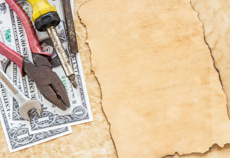 The dollar banknotes and tools on old paper background