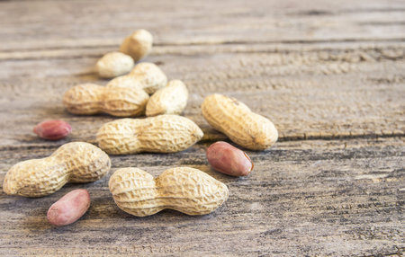 Close up peanuts on a wooden table background