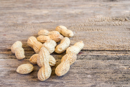 Close up peanuts on a wooden table background
