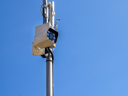 The security camera against blue sky background