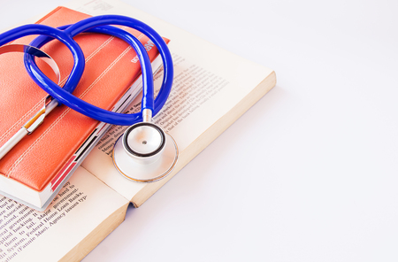 Stethoscope and books on a white background.の写真素材